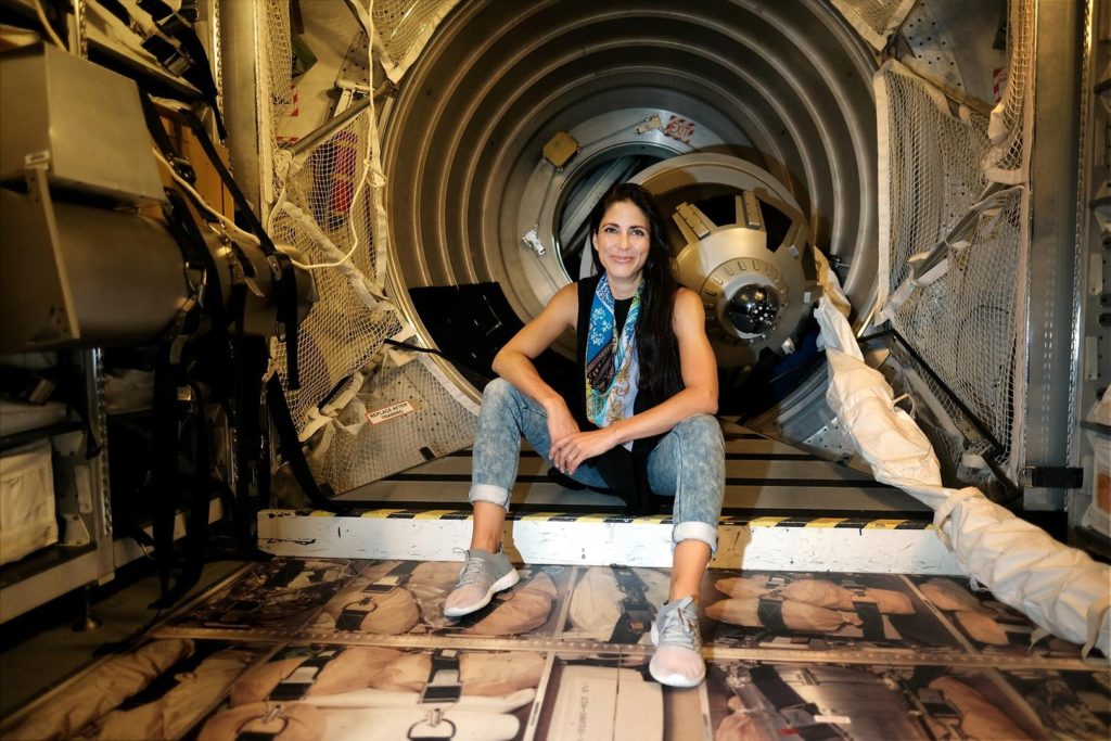 Laura Winterling sitting in a space shuttle